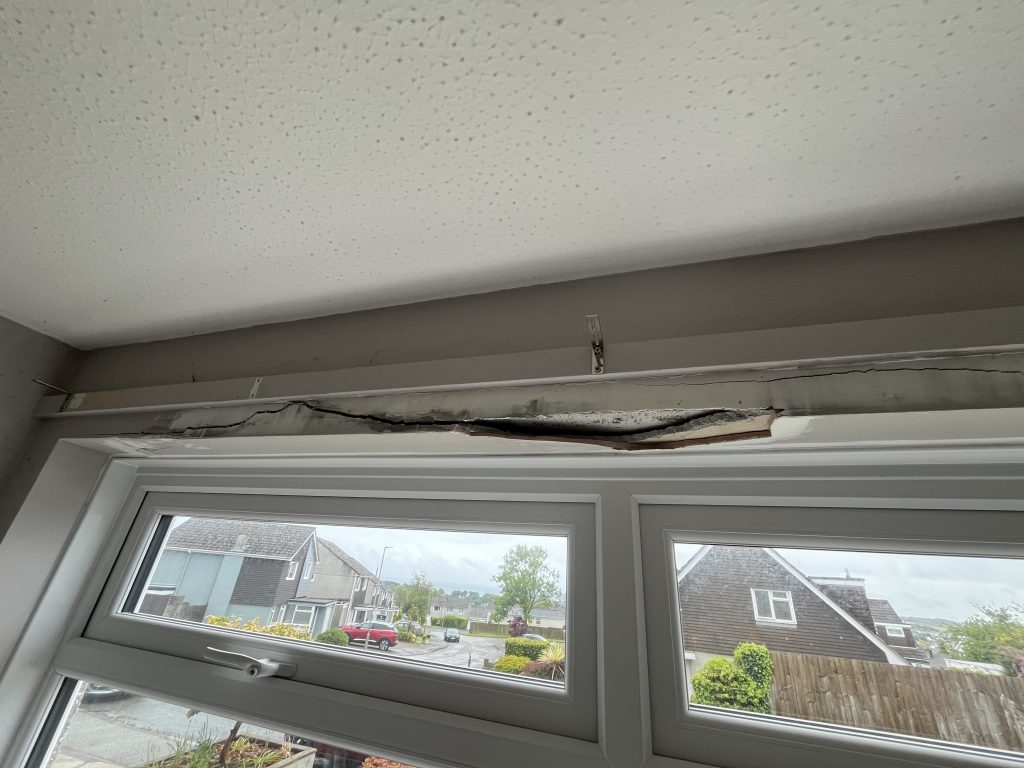 before cracked plaster over window